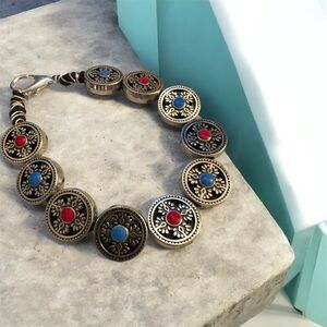 Elegant Gold Bracelet with Red and Blue Accents